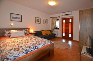 a bedroom with a bed and a couch at Apartments Greta in Rovinj