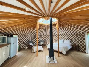 a large room with a bed in a yurt at Ons Yurt Huisje in het Bos in Hollandsche Rading
