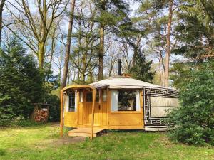 an old rv is sitting in the grass at Ons Yurt Huisje in het Bos in Hollandsche Rading