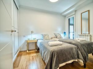 Postel nebo postele na pokoji v ubytování Amara Prime San Sebastian