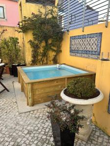 a hot tub in the side of a building at Solar do Castelo - Lisbon Heritage Collection - Alfama in Lisbon