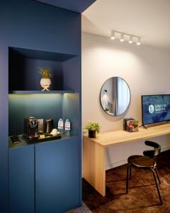a room with a desk and a mirror at Lucky Bansko Aparthotel SPA & Relax in Bansko