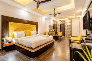 a bedroom with a large bed and a desk at Lime Tree Hotel Huda City Centre in Gurgaon