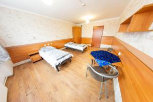 a hospital room with two beds and a table at Twój Hostel Ruda Śląska in Ruda Śląska