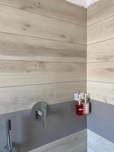 a bathroom with a sink with wooden walls at Ajo' da Paolo in Budoni +13 photos