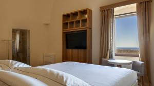 Кровать или кровати в номере La Sommità Relais & Chateaux