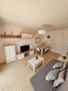 a living room with a couch and a table at Apartamento Playa Piles -Familias- in Piles