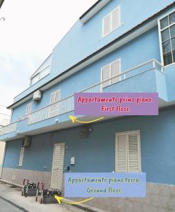 a blue building with a sign on the side of it at Borgata Mazzarelli in Marina di Ragusa