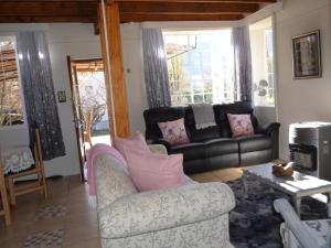 uma sala de estar com um sofá e uma mesa em Gentle Presence Cottages em Clarens