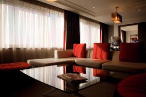 a living room with a couch and a glass table at Pullman London St Pancras in London