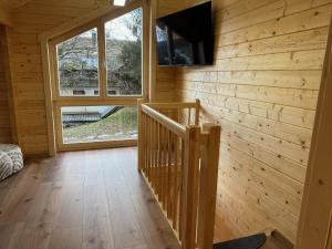 a room with a staircase and a tv on a wall at Hotel Hochfirst in Lenzkirch