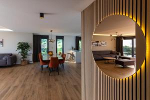 a living room and a dining room with a mirror at Luxury Villa Sirius, Bast, Makarska Rivijera in Bast