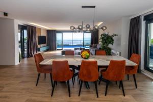 a dining room with a table and chairs and a living room at Luxury Villa Sirius, Bast, Makarska Rivijera in Bast