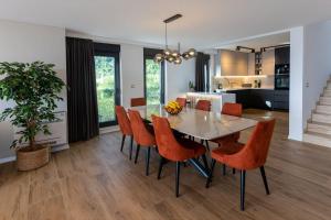a dining room and kitchen with a table and chairs at Luxury Villa Sirius, Bast, Makarska Rivijera in Bast