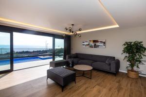 a living room with a couch and a table at Luxury Villa Sirius, Bast, Makarska Rivijera in Bast