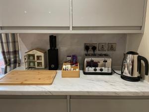 a kitchen counter with a counter top with a microwave and a stove at The Old Stables in Coleford