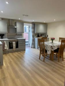 a kitchen and dining room with a table and chairs at The Old Stables in Coleford