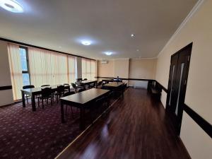a conference room with tables and chairs in it at Georgian Paradise in Kutaisi