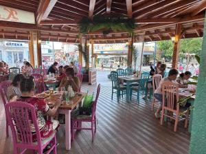 a group of people sitting at tables in a restaurant at Къща за гости КАТИ in Kiten