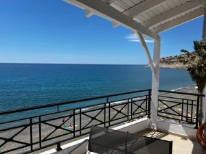 a view of the ocean from the balcony of a house at Thalassa Apartments in Myrtos