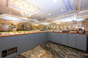 a large kitchen with white cabinets and a counter at Best Nobel HotelS Old City İstanbul-Special category in Istanbul