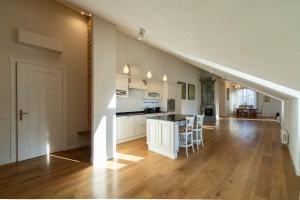an open kitchen and living room with a staircase at Villa Langberg Spa in Ventspils