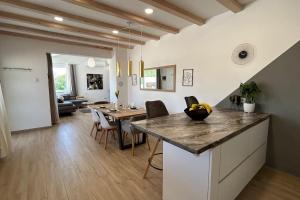 a kitchen and dining room with a table and chairs at Holiday house Diva with a pool in Svetvinčenat