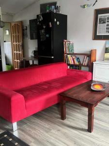 a red couch in a living room with a coffee table at Apartament-samodzielne mieszkanie-Agroturystyka-puszcza kampinoska in Leoncin +27 photos