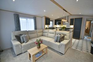 a living room with a couch and a table at Tranquility at Chantry Lodge in Clitheroe