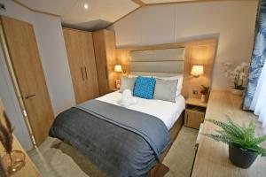 a bedroom with a bed with a stuffed animal on it at Tranquility at Chantry Lodge in Clitheroe