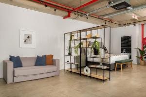 a living room with a couch and a table at Neighbourgood Loop Street in Cape Town