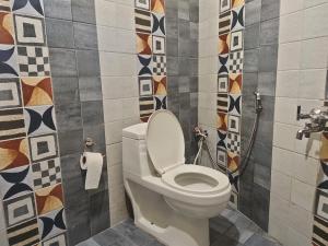 a bathroom with a white toilet in a room at Hotel Olive Branch Darjeeling Near Mall Road - Excellent Customer Service - Parking Facilities - Best Seller in Darjeeling