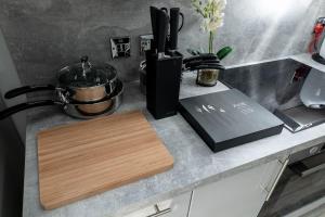 a kitchen counter with a cutting board on a counter top at Beautiful 4 bed flat in perfect central location in Glasgow