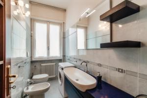 a bathroom with a sink and a toilet and a mirror at Vista Lario Apartment - Aqua Apartments in Cernobbio +34 photos