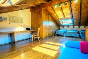 a living room with wooden walls and a blue couch at La Molina IX in La Molina