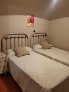 two beds sitting next to each other in a room at MRZ rentals LA CASINA in Cudillero