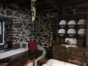 a kitchen with a table and plates on a wall at MRZ rentals LA CASINA in Cudillero