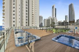 two hot tubs on the roof of a building at Ocean View Surfers Paradise Studio Close to Beach in Gold Coast