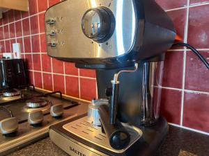 a coffee maker sitting on top of a counter at 2br Spacious City Centre Apartment in Belfast