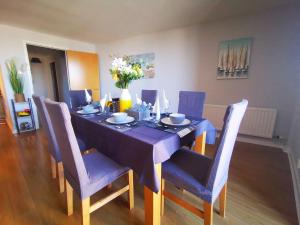 uma mesa de jantar com uma toalha de mesa azul e cadeiras em 2br Spacious City Centre Apartment em Belfast