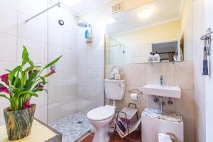 a bathroom with a toilet and a sink at Kings and Kent in Cape Town