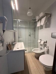 a bathroom with a shower and a toilet and a sink at Crispi 10 in Floridia