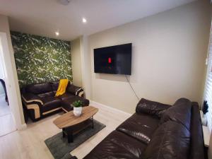 a living room with a couch and a table at 4br Modern Botanic House in Belfast