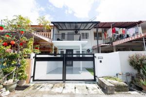 a house with a pivot door in front of it at Mono Ipoh - Bercham, 2 parking, sleep 10, Lost World Tambun in Ipoh