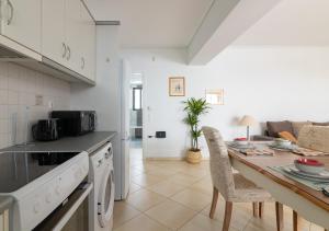 a kitchen with a counter and a table with chairs at Elegant Apt 50meters Close Acropolis in Athens