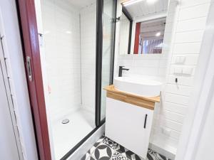 a bathroom with a shower and a sink at Red Tiny House in Sopot +8 photos