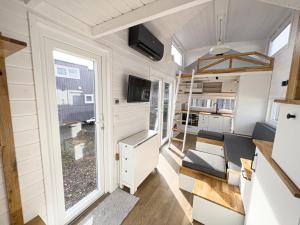 a tiny house with a kitchen and a living room at Red Tiny House in Sopot