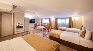 a hotel room with two beds and a living room at Orya Hotel in Istanbul