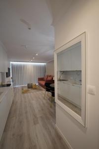 a living room with a large television on a wall at Apartament nad Morzem w Sea & Lake Mielno in Mielno