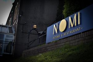 a sign for a nonum sign on the side of a building at Nomi Rooms & Restaurant in Bangor